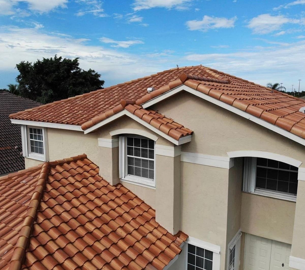 Two-storey stucco home with a new barrel tile roof